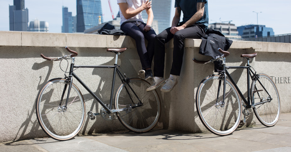 Two cyclists sitting on a wall together with their Fox Wilson clothing and Orro's FE Street