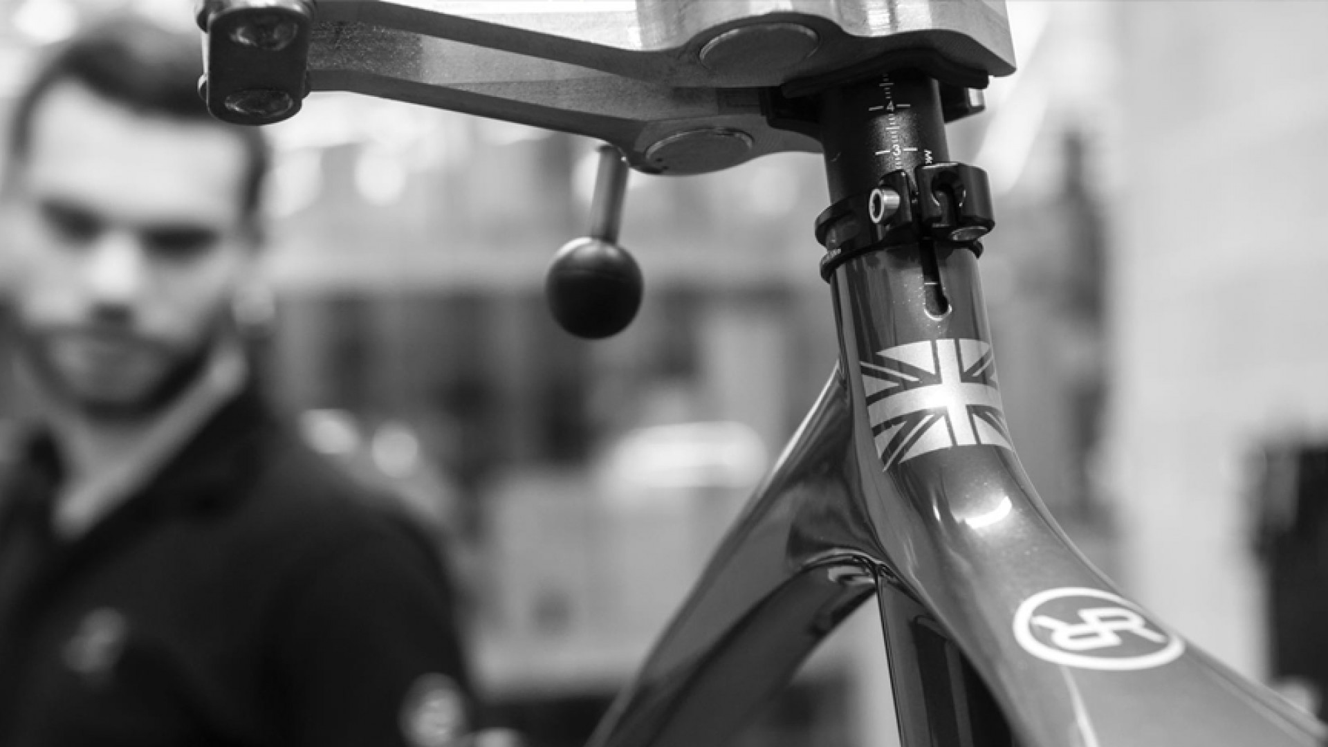 Black & White closeup shot of an craftsman putting together an Orro Bike
