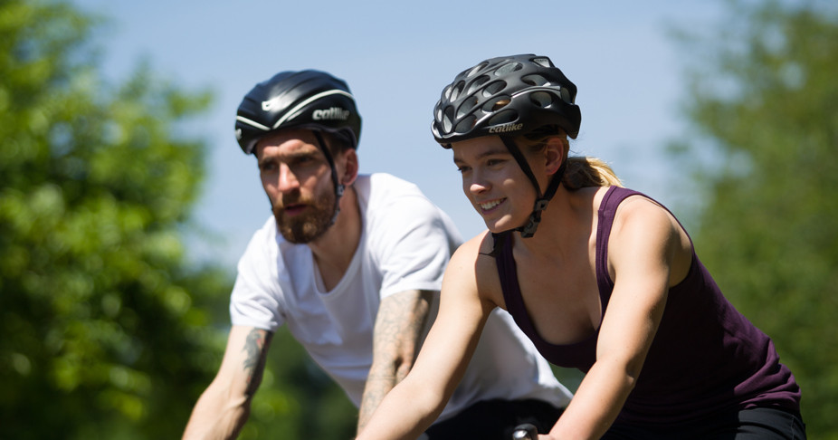 Closeup of two cyclists cycling together wearing Fox Wilson clothing on a summers day