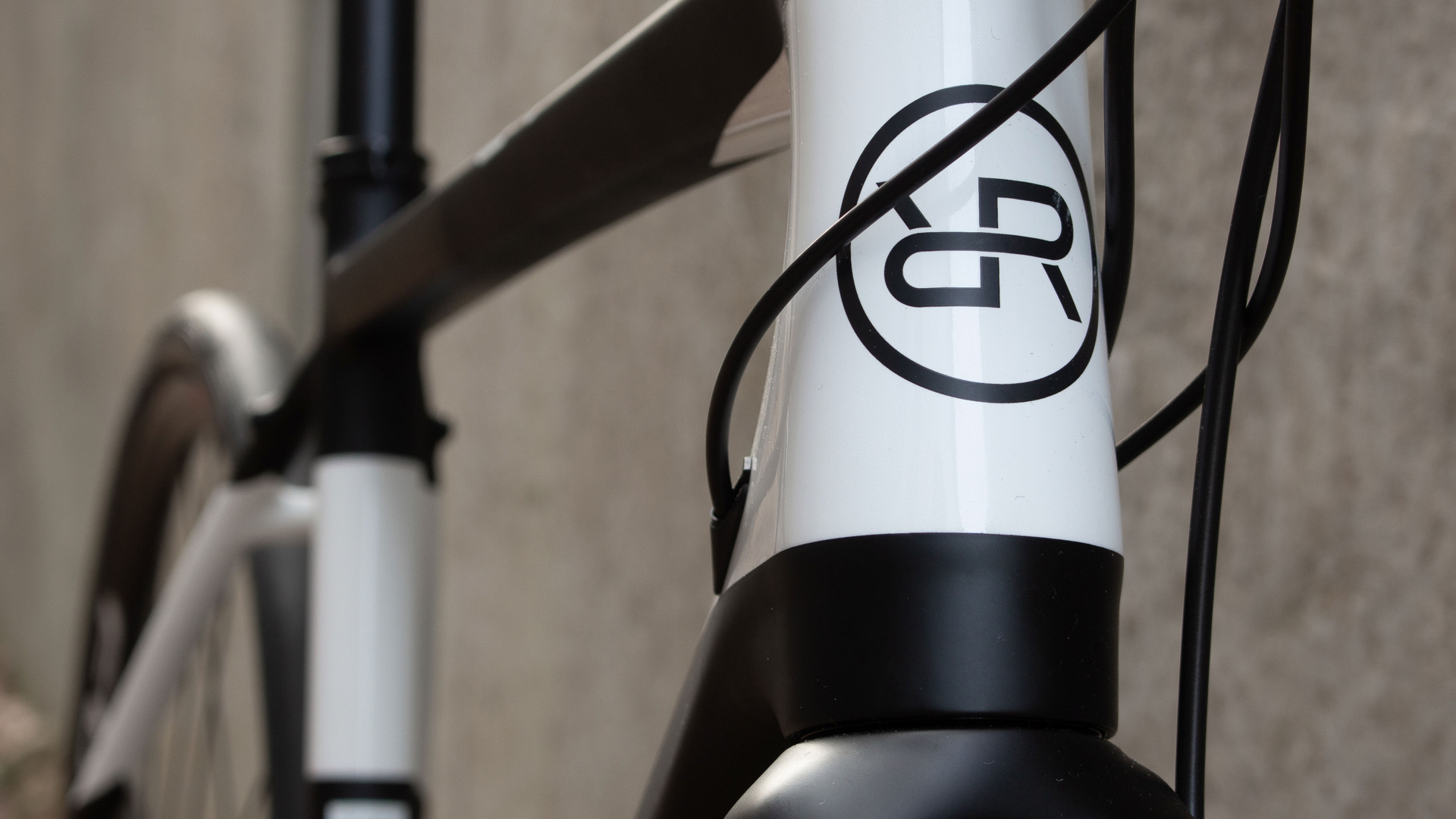 Close up photo of the black carbon bike frame with the Orro Bikes logo finished in black with a white background