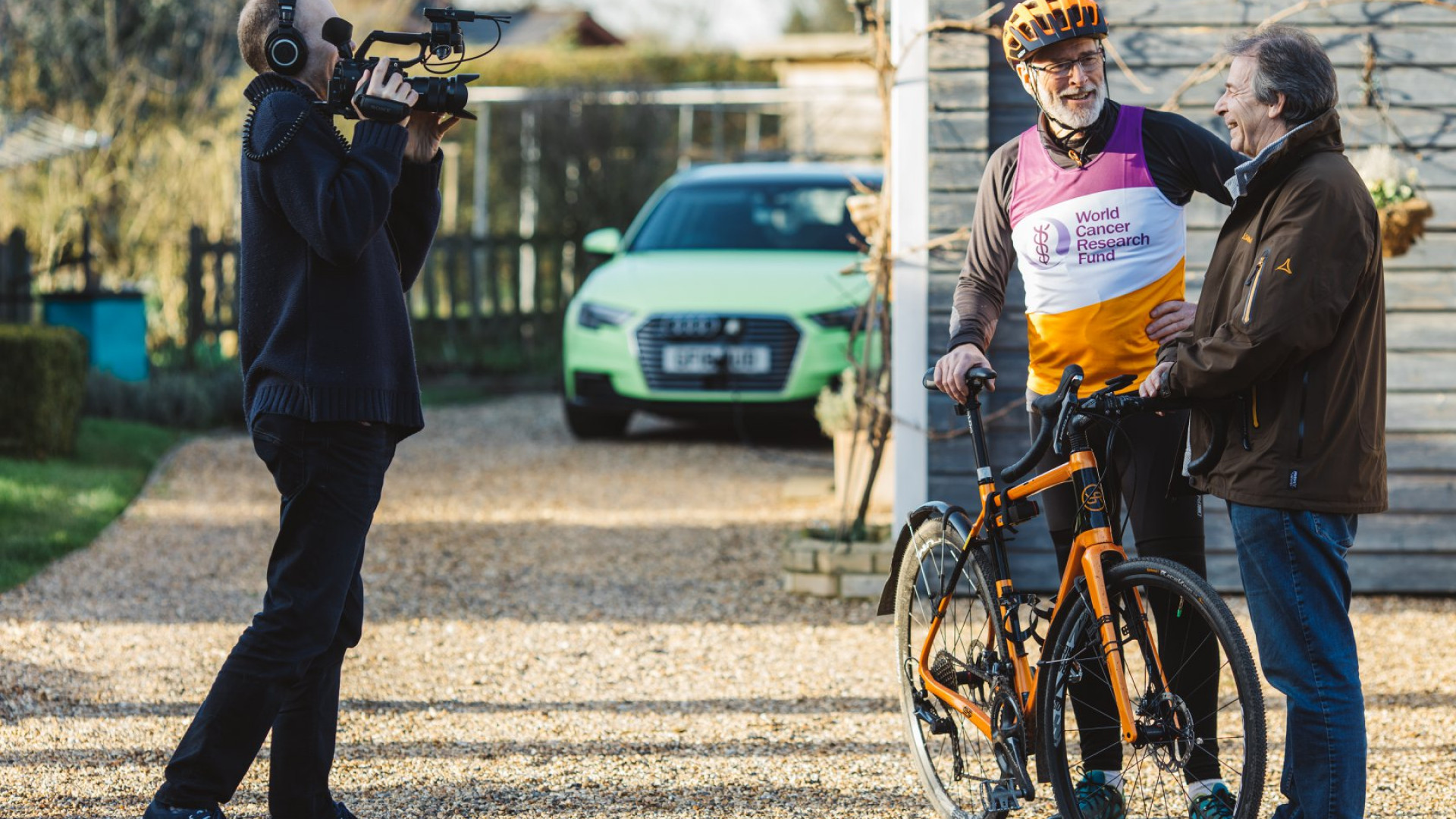 Patrick McIntosh Holding His Orro Bike Whilst Being Interviewed and Filmed For TV