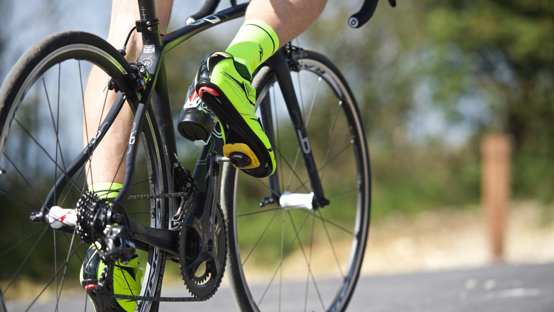 Closeup photograph of the bottom half of a cyclist riding his Orro Bike