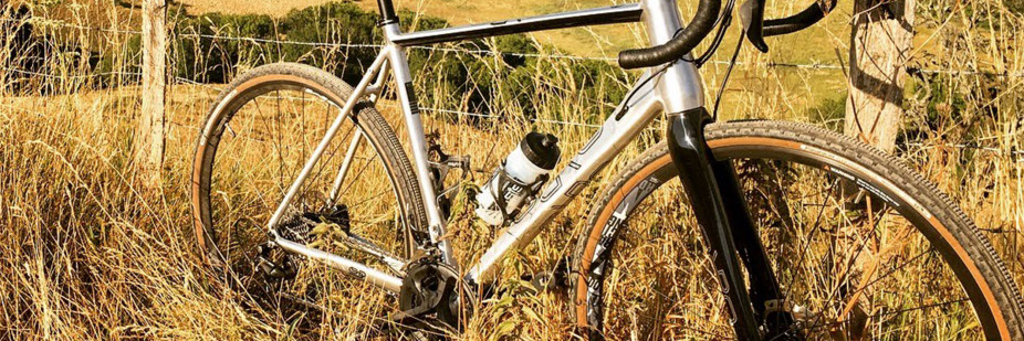 Orro Terra Gravel Road Bike leaning on a fence in a field